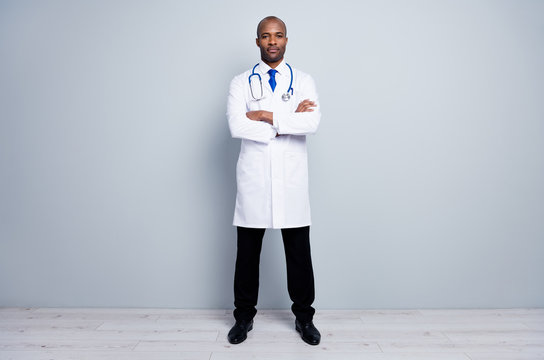 Full body photo of professional family doctor dark skin guy meet patients virologist arms crossed wear white long lab coat neck tie pants shoes isolated grey color background
