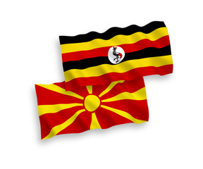 Fototapeta premium Flags of Uganda and North Macedonia on a white background