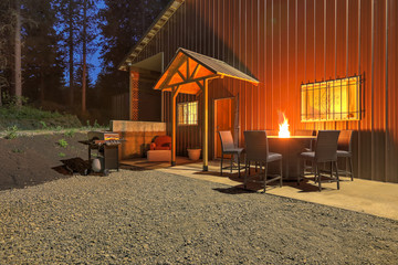 Front entrance to large metal shop, barn building with guest house and cozy outdoor set up.