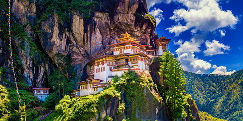 Panorama view of Tiger nest monastery on a bright bluesky day, Taktshang Goemba, Paro, Bhutan - obrazy, fototapety, plakaty