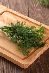 Fresh and fragrant dill on a wooden board