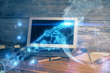 Computer on desktop in office with technology theme hologram. Multi exposure. Tech concept.