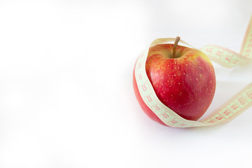 Red apple and tape measure isolated on white. copyspace for text.