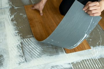 luxury vinyl floor tile : using Notched trowel glue on cement floor step of work to install vinyl...