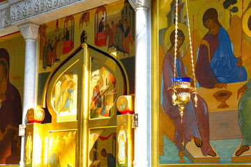 Church lamp in front of the icon. A burning lamp, a candle in a blue flask sways in front of the...