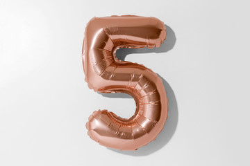 Number 5, Rose gold foil balloon number five isolated on a white background with Clipping Path