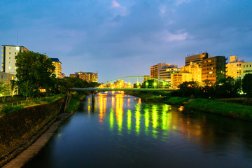 Fototapeta na wymiar View of a bridge over the Shirakawa river in Kumamoto, Japan