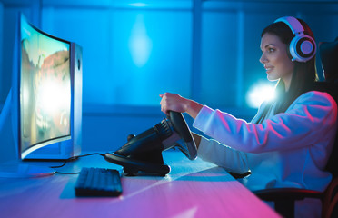 The gamer girl playing video games at the dark room © Artem