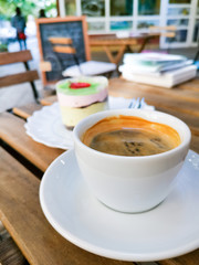 White cup of hot coffee on table