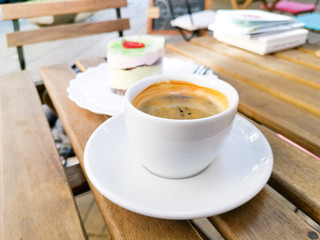 White cup of hot coffee on table