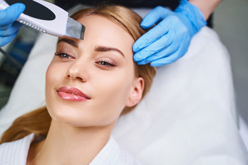 Relaxed girl getting her face peeled stock photo