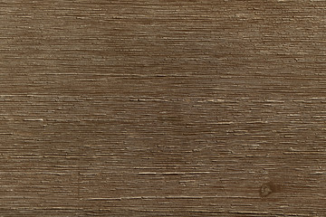 Photographed texture of dark brown wood in a horizontal position with grain.