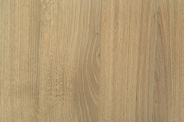 Photographed texture of wood with wood grain in the middle in a yellow brown color