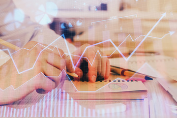 Multi exposure closeup hands with stock market forex graph.