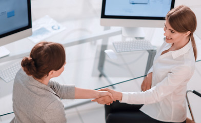 Obraz premium view from the top.business woman shakes hands with the officer s