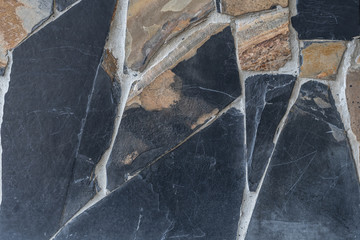 The brown and dark gray stone slates background.
