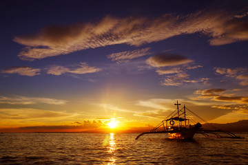 silhouette of boat on the beach during sunset in philippines 