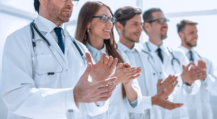 Fototapeta na wymiar group of doctors applauds, standing in the hospital