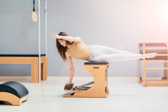one caucasian woman exercising fitness pilates exercices isolated on white background