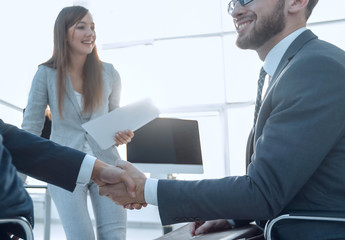business handshake in an office.