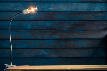 abstract Old wooden backdrop with Tungsten filament lamps on wooden floor.