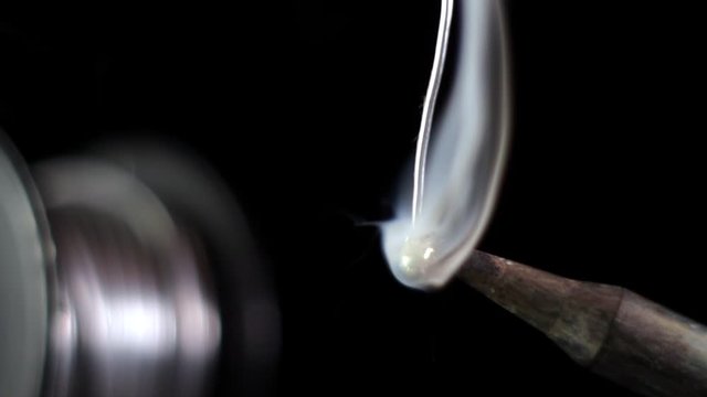 Melted solder wire over a hot soldering iron tip.