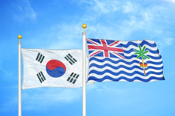South Korea and British Indian Territory two flags on flagpoles and blue cloudy sky