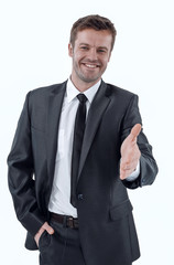 handsome businessman holds out his hand for a handshake.
