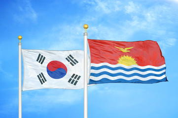 South Korea and Kiribati two flags on flagpoles and blue cloudy sky