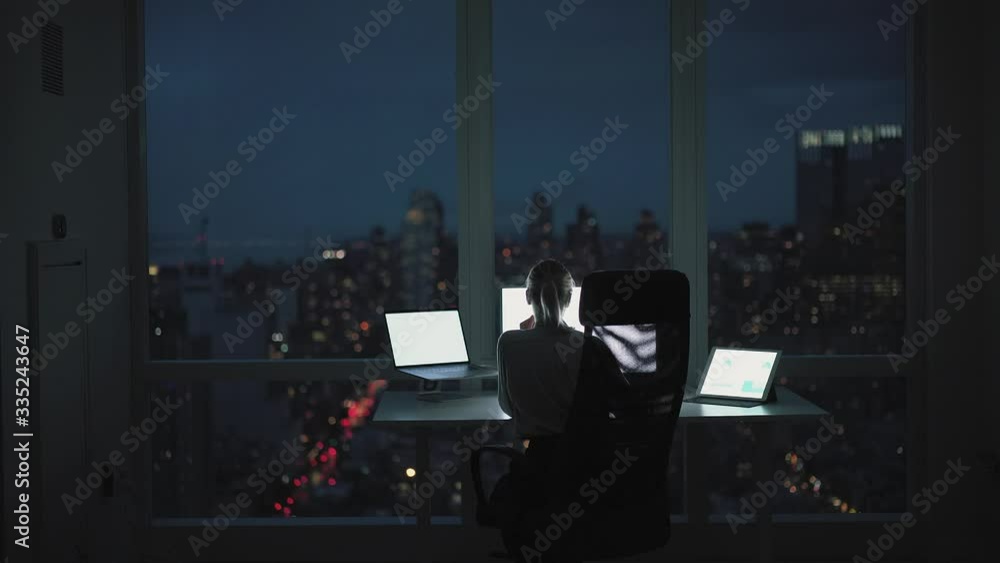 Poster back view of millennial female administrator using synchronized device for making digital browsing d