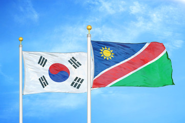 South Korea and Namibia two flags on flagpoles and blue cloudy sky