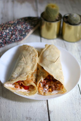 Homemade tortillas with chicken, vegetables and sauce. Selective focus.