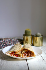 Homemade tortillas with chicken, vegetables and sauce. Selective focus.