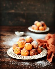 Cottage cheese donuts in a ceramic dish on a dark wooden table