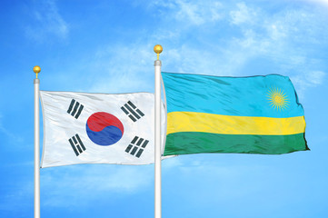 South Korea and Rwanda two flags on flagpoles and blue cloudy sky