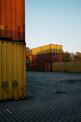 Terminal with colorful containers in the sunset vertical