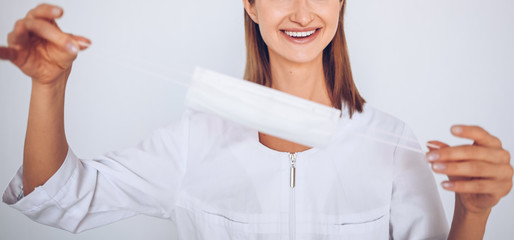 Close up portrait unrecognizable young european woman doctor nurse wearing protective mask corona virus prevention. Free space for text mockup banner. Avoid contaminating Corona virus Covid-19 concept