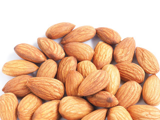 A pile organic almonds seed isolated on a white background. Close up.