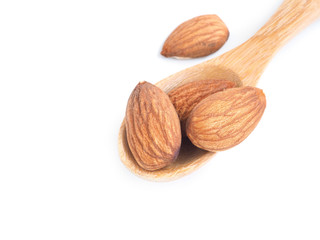 Almonds seed in wooden spon on a white background..