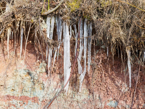 photo with white ice icicles on the red clay walls
