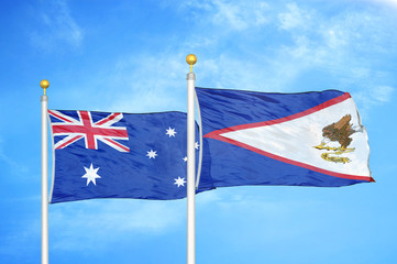 Australia and American Samoa two flags on flagpoles and blue cloudy sky