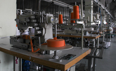 sewing machine in a large sewing shop, factory