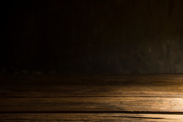 Old wood table on dark background.