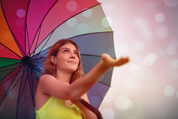 Happy woman with umbrella enjoying rain