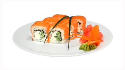 Rolls with salmon, cucumber and cheese on white round plate