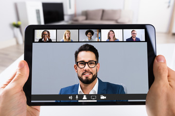 Person Video Conferencing With Doctor On Digital Tablet