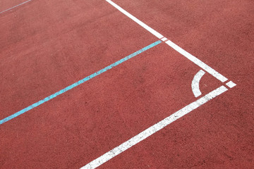 Close-up of white marking lines of outdoor basketball court.