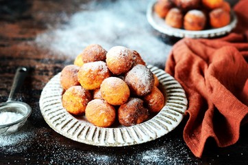 Cottage cheese donuts in a ceramic dish on a dark wooden table