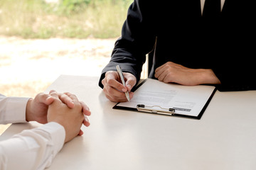 Business people hold a job profile and talk to job applicants for job interviews about careers and...