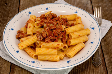 Rigatoni pasta with Bolognese ragu, traditional italian pasta with tomato sauce, meat and vegetables.